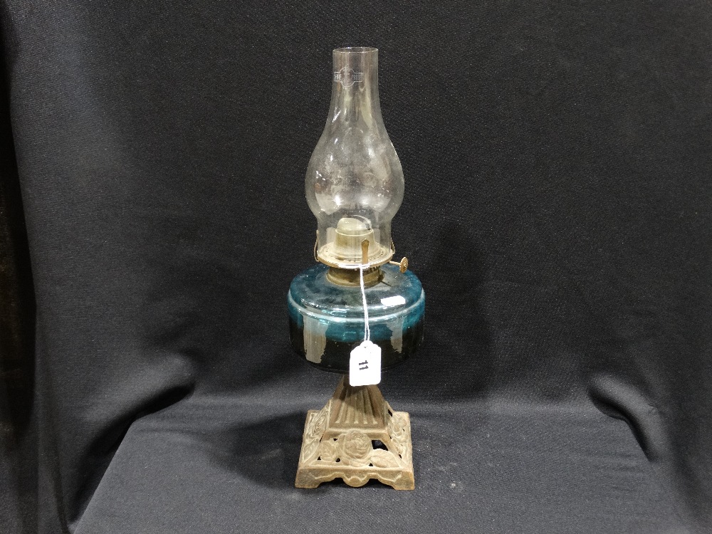 A Metallic Based Oil Lamp With Blue Glass Reservoir