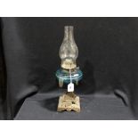 A Metallic Based Oil Lamp With Blue Glass Reservoir
