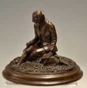 Sir David Hughes bronze resin fishing figure: sitting on a naturalistic river bank selecting a fly -