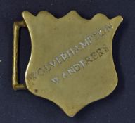 Brass buckle with loop for the belt and fixing hook for belt adjustment; to the outer face it is