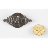 Silver Plated Tennis Brooch depicting two females playing tennis, a circular style brooch with pin