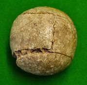 Unnamed large featherie golf ball with the stitches to one seam partially undone -