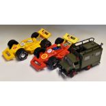 2x Corgi Carry Car Plastic Cases in the shape of F1 cars, one in red the other in yellow, together