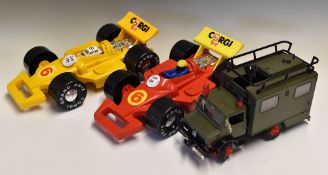 2x Corgi Carry Car Plastic Cases in the shape of F1 cars, one in red the other in yellow, together