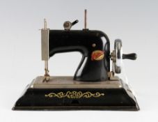 EMG Comet Plastic and Tinplate Sewing Machine in black, in working order.