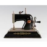 EMG Comet Plastic and Tinplate Sewing Machine in black, in working order.