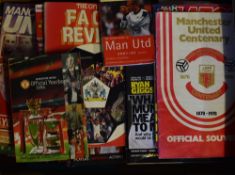 Collection of Manchester United souvenirs, including programmes, also has sticker albums and other