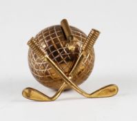 Interesting brass guttie golf ball tape measure c. 1900 - fitted with hinged crossed golf clubs to