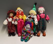 Porcelain Clown Dolls one a wind-up music playing doll, the others dressed in various outfits with