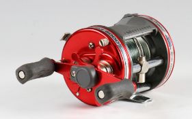 Abu Ambassadeur 6000 level wind casting reel: red domed end plate, twin ergonomic handles very