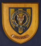 A Wolves (circa 1920's style) polished hardwood plaque in the form of a shield depicting a wolf