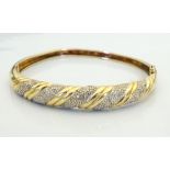 DIAMOND SET UNMARKED NINE CARAT GOLD BANGLE with safety clasp, approximately 12.