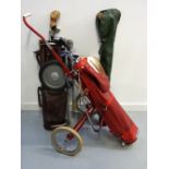 COLLECTION OF VINTAGE GOLF CLUBS with period bags (one leather) and two trolleys