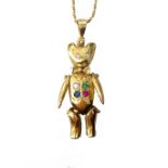 GEM SET NINE CARAT GOLD TEDDY BEAR PENDANT with articulated limbs and neck,