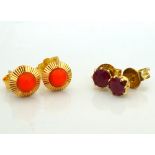 TWO PAIRS OF STUD EARRINGS comprising coral in eighteen carat gold and ruby in fourteen carat gold