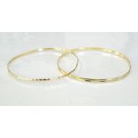 TWO FOURTEEN CARAT GOLD BANGLES total weight approximately 7.