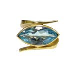 MODERN DESIGNER AQUAMARINE SINGLE STONE RING on heavy crossover eighteen carat gold shank,