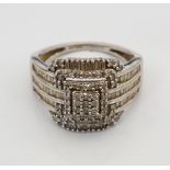 DIAMOND CLUSTER DRESS RING on nine carat white gold shank, the diamonds totalling approximately 1ct,