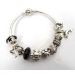 PANDORA SILVER CHARM BANGLE with ten Pandora charms including a turtle, a CZ set star,