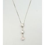 ATTRACTIVE DIAMOND SET DROP PENDANT the three round brilliant cut diamonds linked by diamond set