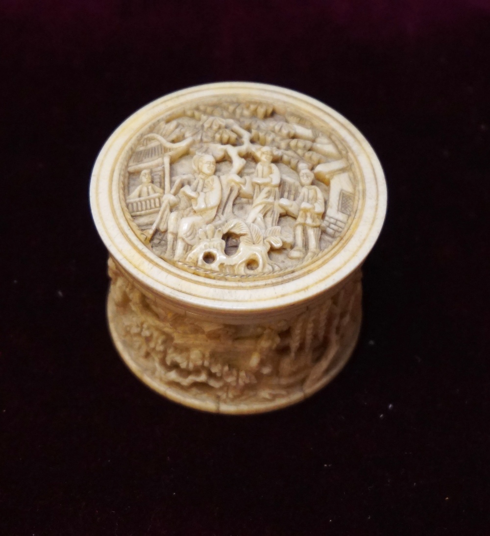19th CENTURY CHINESE CARVED IVORY CIRCULAR BOX AND COVER profusely decorated overall with figures