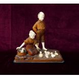EARLY 20th CENTURY CONTINENTAL CARVED IVORY AND STAINED WOOD FIGURE GROUP depicting a mother and