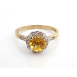 CITRINE AND DIAMOND CLUSTER DRESS RING the central round brilliant cut citrine in diamond surround