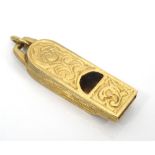 NINE CARAT GOLD WHISTLE CHARM with scroll decoration overall, approximately 5.