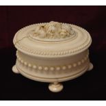 19th CENTURY CONTINENTAL CARVED IVORY OVAL TRINKET BOX the lift up lid decorated with a central