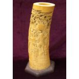19th CENTURY JAPANESE CARVED IVORY TUSK SECTION profusely decorated with a busy village scene below