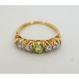 EDWARDIAN PERIDOT AND DIAMOND FIVE STONE RING the central peridot flanked by diamonds,