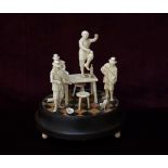 19th CENTURY CONTINENTAL CARVED IVORY AND STAINED WOOD FIGURE GROUP depicting a tavern scene with