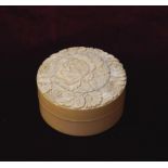 19th CENTURY JAPANESE CARVED IVORY CIRCULAR BOX the cover profusely decorated with flower heads, 6.