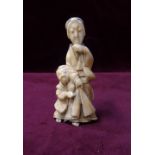 19th CENTURY JAPANESE CARVED IVORY OKIMONO depicting a mother and child,