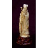 19th CENTURY JAPANESE CARVED IVORY OKIMONO depicting a wise sage dressed in flowing robes and