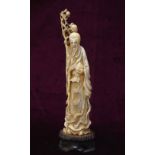 LATE 19th CENTURY CHINESE CARVED IVORY FIGURE OF A BEARDED SAGE in elaborately decorated robes,