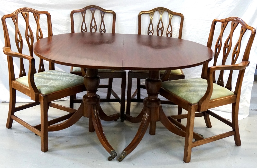 MAHOGANY D END DINING TABLE with an extra leaf, standing on twin turned columns,