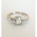 AQUAMARINE AND DIAMOND DRESS RING the central oval cut aquamarine approximately 1ct flanked by