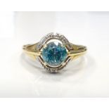 BLUE ZIRCON AND DIAMOND DRESS RING on nine carat gold shank,