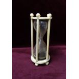 EARLY 19th CENTURY CONTINENTAL IVORY MOUNTED HOUR GLASS TIMER the shaped glass body encased by five