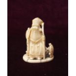 19th CENTURY JAPANESE CARVED IVORY NETSUKE in the form of a wise man holding a fan and staff with a