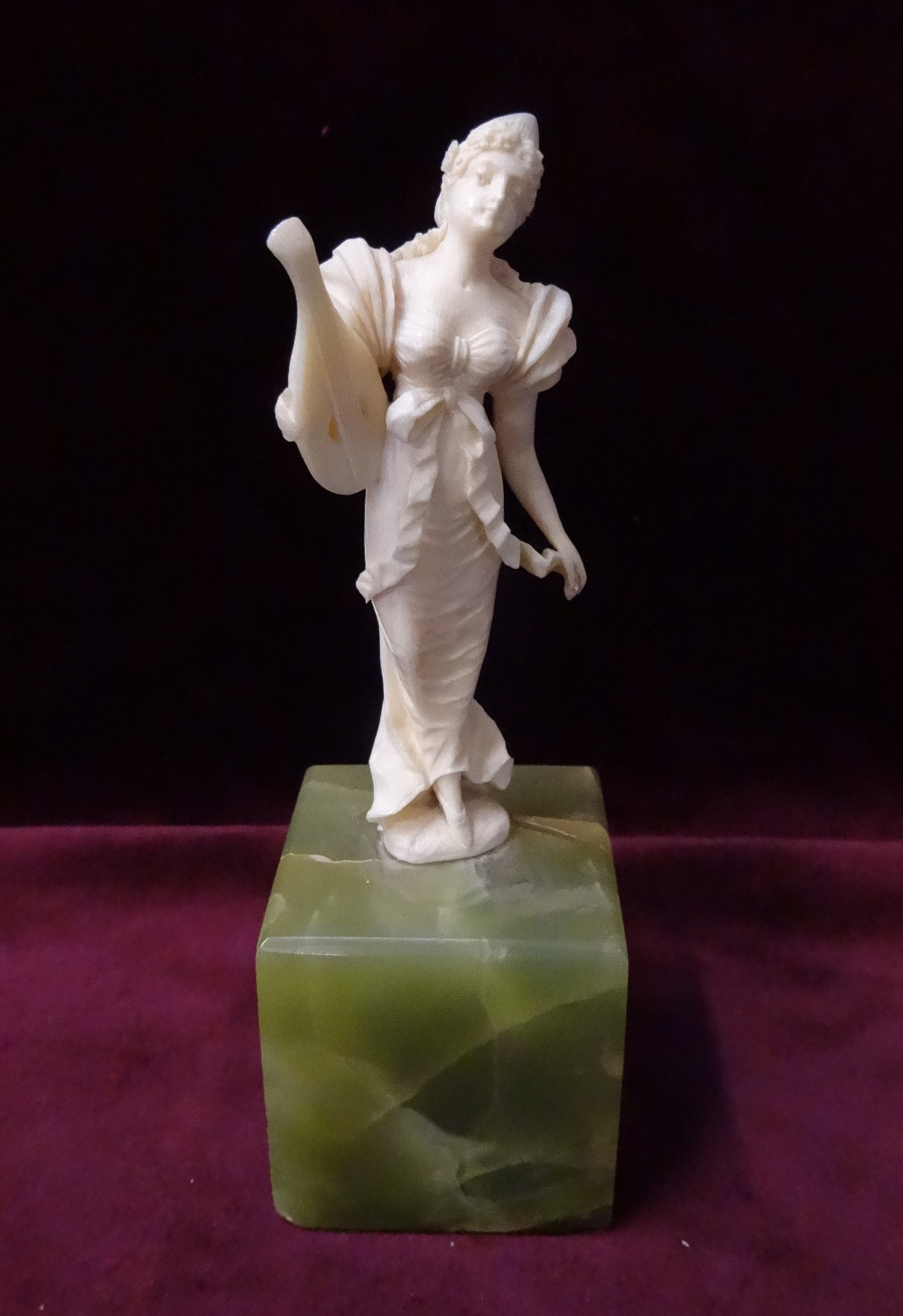 LATE 19th CENTURY CONTINENTAL CARVED IVORY FIGURE OF A WOMAN holding a lyre and dressed in