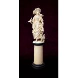 19th CENTURY CONTINENTAL CARVED IVORY FIGURE OF A WOMAN in flowing robes and holding a basket,