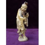 19th CENTURY CHINESE CARVED IVORY FIGURE OF AN OLD MAN in flowing robes and smoking a pipe, 13.