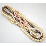 FOUR PEARL NECKLACES including one black pearl examples;