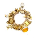 IMPRESSIVE NINE CARAT GOLD CHARM BRACELET with a large selection of interesting charms,