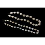 GRADUATED IVORY BEAD NECKLACE with twenty six oval beads and another similar with twenty one oval