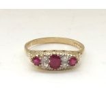 RUBY AND DIAMOND CLUSTER RING the three graduated rubies separated by small diamonds,