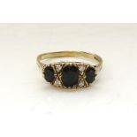 SAPPHIRE AND CZ CLUSTER RING the three graduated sapphires with small CZ stones between,