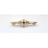 EDWARDIAN SAPPHIRE AND SEED PEARL FIFTEEN CARAT GOLD BROOCH the central round cut sapphire